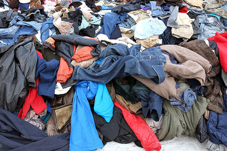 Pile of donated clothing ready for sorting.